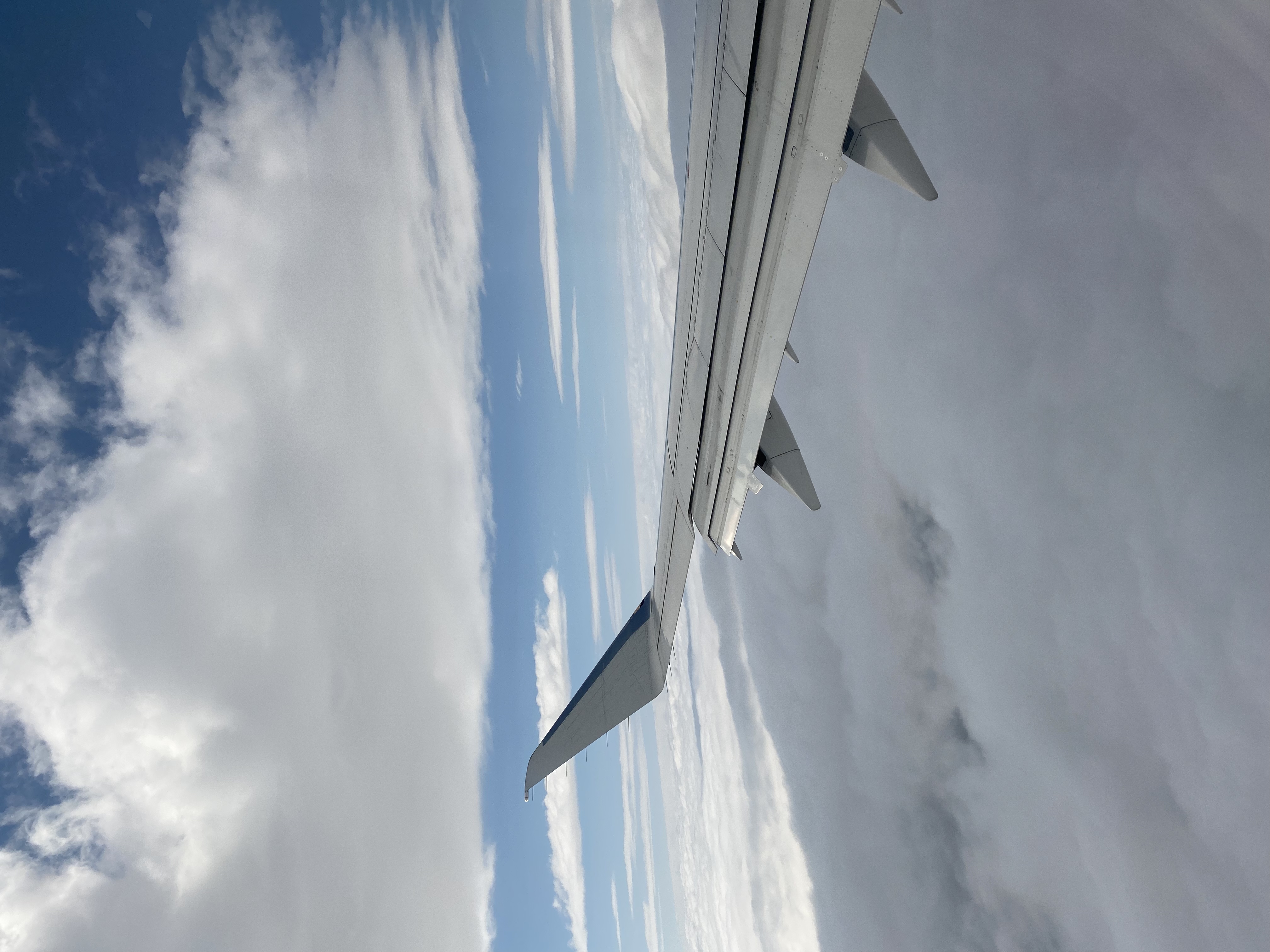 airplane wing, clouds in the sky